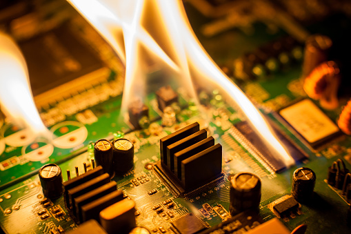 fire-burning-circuit-board-with-electronic-picture-id881003482