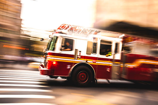 Fire department truck in emergency Fire department truck in emergency in New York streets. 911 new york stock pictures, royalty-free photos & images