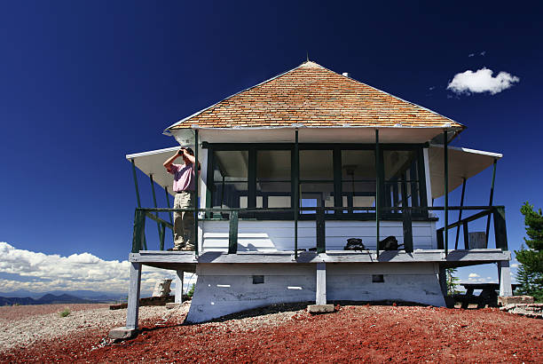 Fire lookout in the Cascades Man with binoculars at the Little Mt. Hoffman Fire Lookout. fire lookout tower stock pictures, royalty-free photos & images