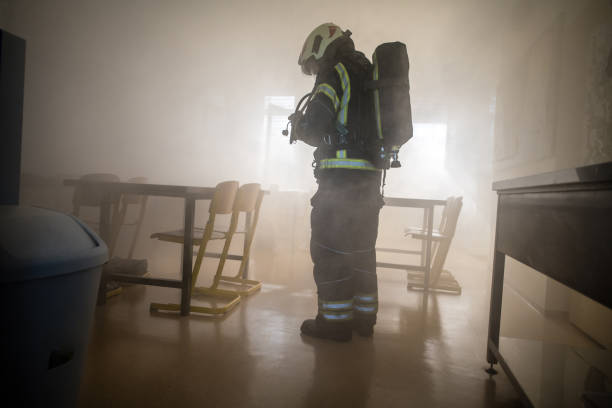 Firefighter in Smoke, Fire Rescue Operation stock photo