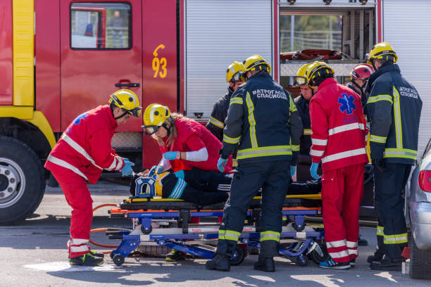 Firefighters and ambulance team rescue the injured at safety drill. stock photo