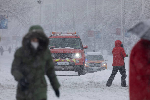 Firefighters and SAMUR's off-road vehicles on a snowy day, Madrid. Madrid, Spain - January 09, 2021: Firefighters and SAMUR's off-road vehicle, public services in emergency, on a snowy day, due to the Filomena polar cold front. public service stock pictures, royalty-free photos & images