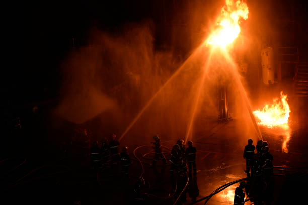 Fireman in firefighting at night. stock photo