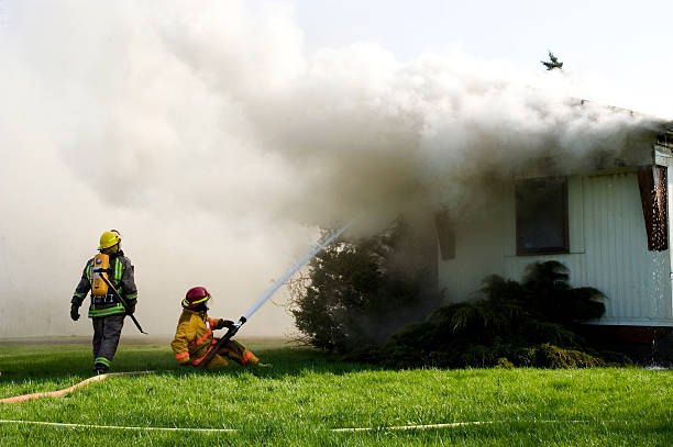 Firemen Fighting Residential Fire stock photo