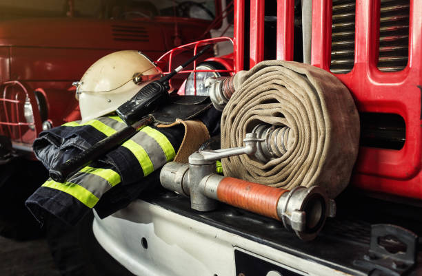 Firemen gear on firetruck such as fire barrel, special clothing, ration, helmet and hydrant stock photo