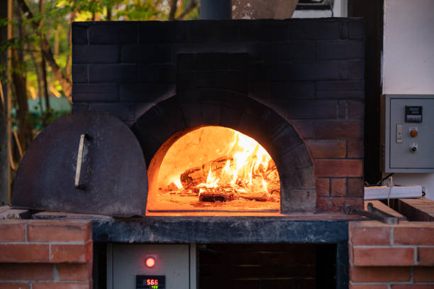 Firewood burning in pizza stove at pizzeria stock photo