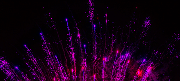 Fireworks Fourth of July USA Glitter Light Sparks Confetti Dust Particle Exploding Spray Red Blue Purple Magenta Ultra Violet Black Background Fountain In a Row Blurred Motion Copy Space for presentation, flyer, greeting card, poster, brochure, banner