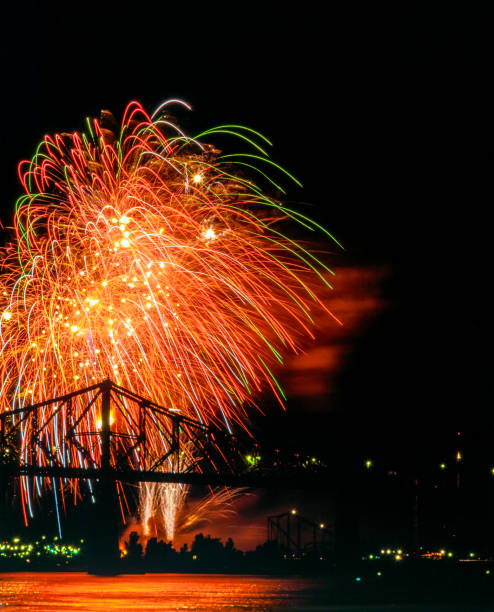 Fireworks with Jacques Cartier bridge in silhouette stock photo