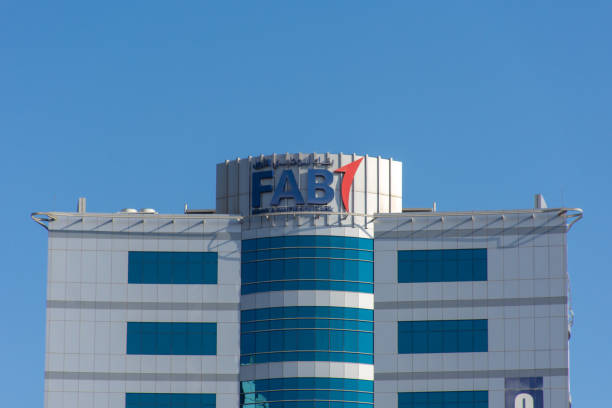 First Abu Dhabi (FAB) Bank blue logo on large building top on a blue sky sunny day stock photo