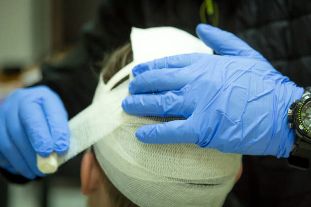 First aid training, head bandage stock photo