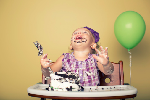 Let them eat cake and enjoy it. A girl celebrates her first birthday.