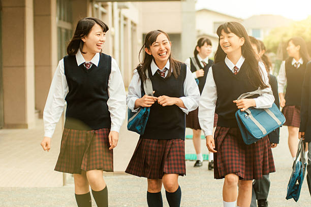 First day of school in Japan Japanese teenage students in uniforms walking to School japanese girl stock pictures, royalty-free photos & images