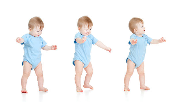 First steps of baby on white background stock photo