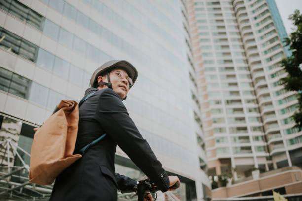 First time of businessman riding an e-scooter in the city. stock photo