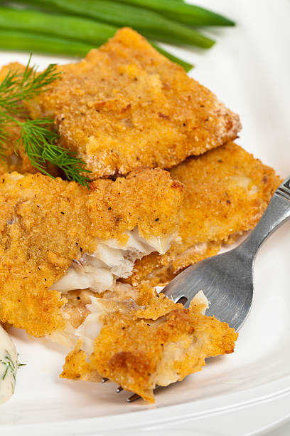 Fish dish Breaded White Fish Fillets. Selective focus. fried fish stock pictures, royalty-free photos & images