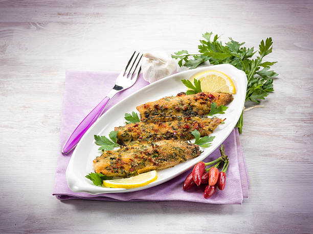 fish fillet with  hot chili pepper and parsley stock photo