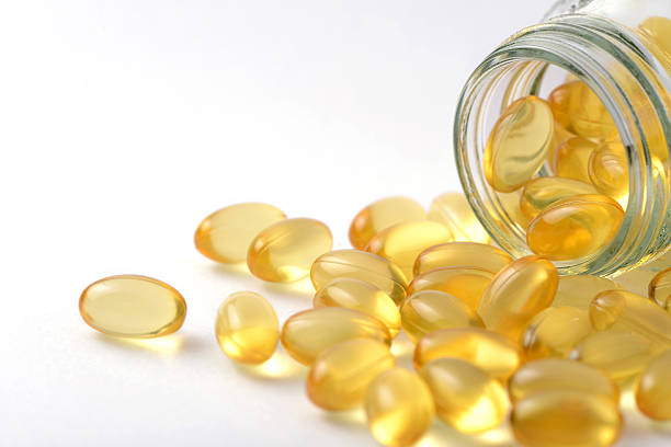 Fish oil and Evening Primrose capsules pills and container stock photo