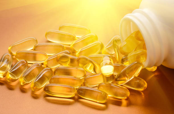Fish oil and vitamin D softgels vitamin d sun stock pictures, royalty-free photos & images