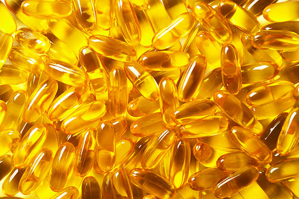 Fish Oil capsules Close up of fish oil capsules. fish oil stock pictures, royalty-free photos & images