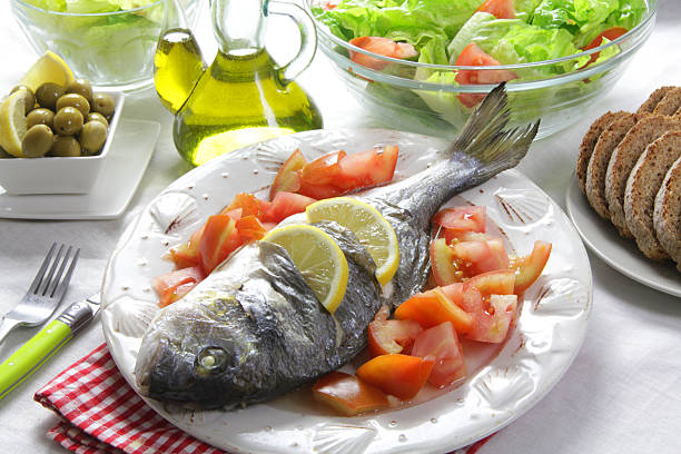 fish with a lemon on a plate stock photo