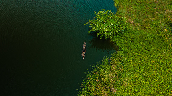 Victoria Island Lagos, Nigeria - 15 March 2022: Drone view of a fisherman on a fishing boat in Kuramo waters