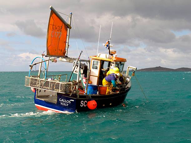 fishermen in fishing boat, Isles of Scilly, Cornwall, England stock photo