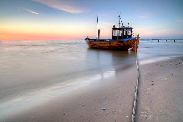 Fishing boat on the Baltic Sea beach stock photo