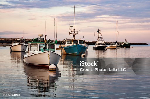 istock Fishing boats in a harbor Camp Ellis, Maine, on a summer day 1331966840