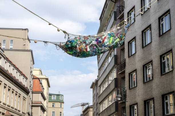 Fishing net full of plastic bottles Fishing net full of plastic bottles hanging over the street during day prague art stock pictures, royalty-free photos & images