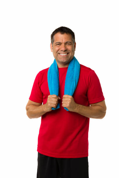 Fit and healthy adult man with towel around his neck smiling at camera stock photo
