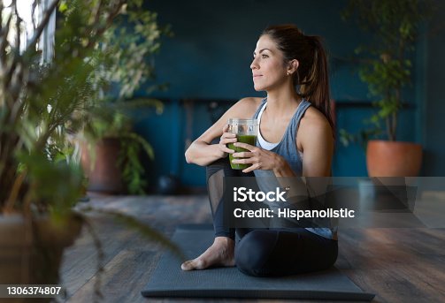 istock Fit woman drinking a green detox smoothie at the gym 1306374807