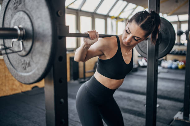 Fit woman weightlifting stock photo