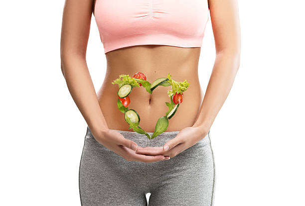 Fit, young woman holding a heart made out of vegetables stock photo