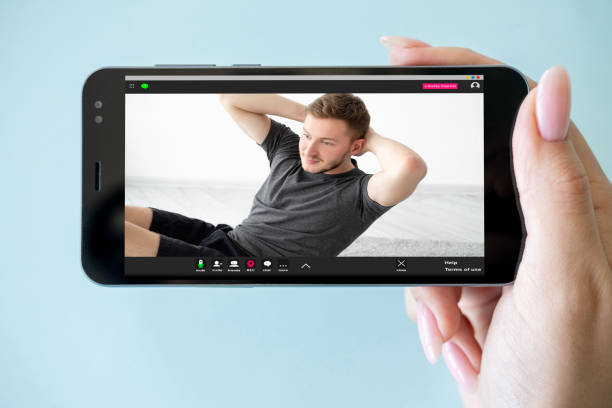 fitness app virtual gym smartphone man exercise stock photo