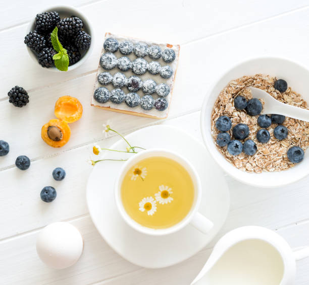 Fitness breakfast: granola with berries and fruits, eggs and tea. stock photo