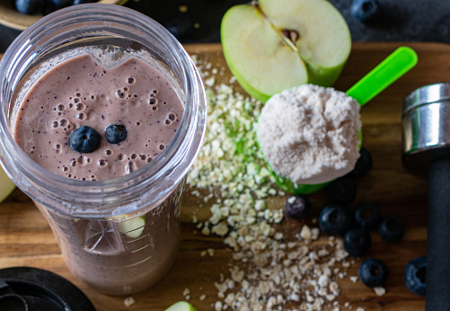Fitness Breakfast Smoothie with fresh blueberries, apples, oatmeal and whey protein powder served in a drinking cub