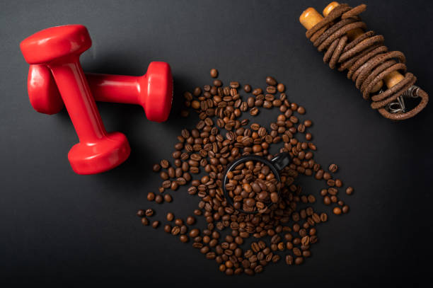 Fitness equipment and coffee. Fitness skipping rope and red dumbbells. Fitness equipment and coffee. Fitness skipping rope and red dumbbells. Flatlay. caffeine stock pictures, royalty-free photos & images