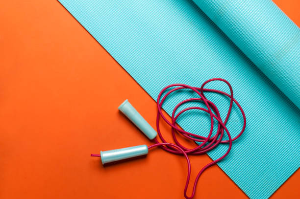 fitness mat with jump rope stock photo