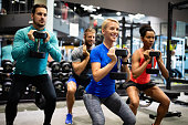 istock Fitness, sport, training, gym, success and lifestyle concept. Group of happy friends in the gym 1282884610