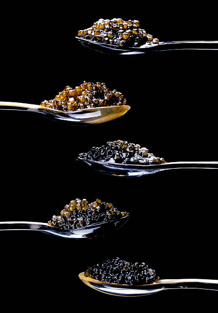 five different kinds of caviar on black close up of five spoons with caviar on a black background roe stock pictures, royalty-free photos & images