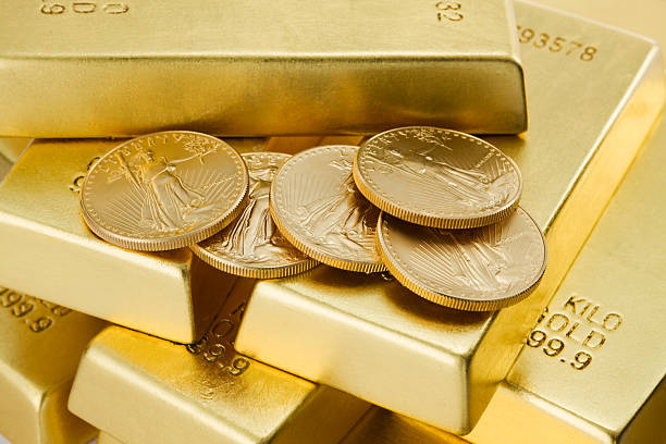 Five gold coins on top of lots of gold bars Gold Coins and Ingots gold bar stock pictures, royalty-free photos & images