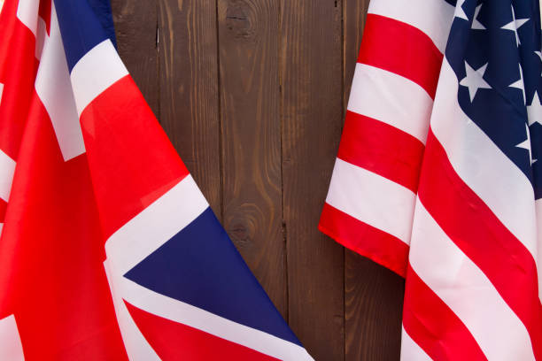 UK flag and USA Flag on wooden brown background. stock photo