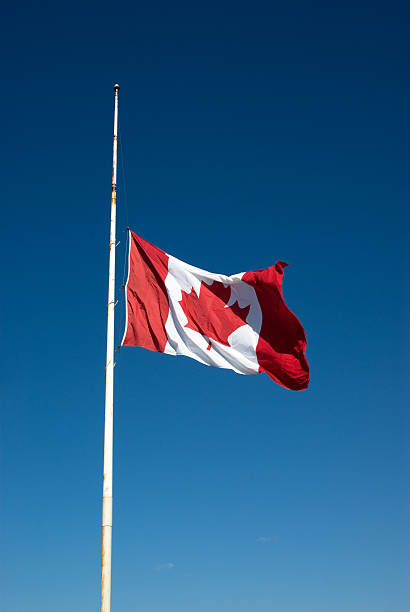 Flag at Half Mast A Canadian flag flying at half mast out of respect for a recent death.Related Images: flag at half staff stock pictures, royalty-free photos & images