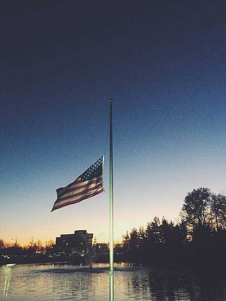 USA Flag at Half Mast USA Flag at half mast half staff. Processed with VSCOcam with f2 preset flag at half staff stock pictures, royalty-free photos & images