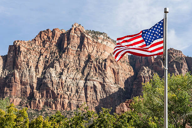USA flag in front of mountains stock photo