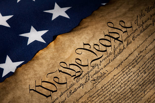USA flag next to the Bill of Rights US Bill of Rights and Flag with spot lighting 1776 american flag stock pictures, royalty-free photos & images