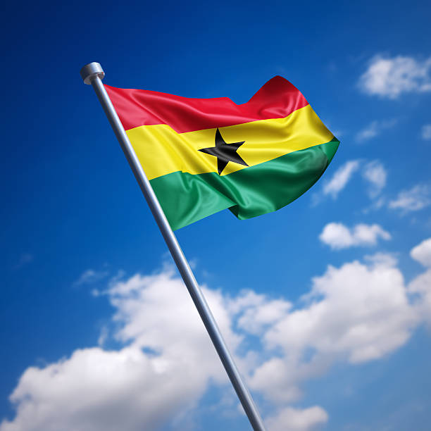 Flag of Ghana against blue sky stock photo