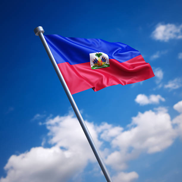 Flag of Haiti against blue sky stock photo