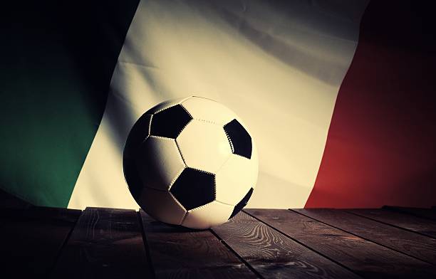 Flag of Italy with football on wooden boards as background. stock photo
