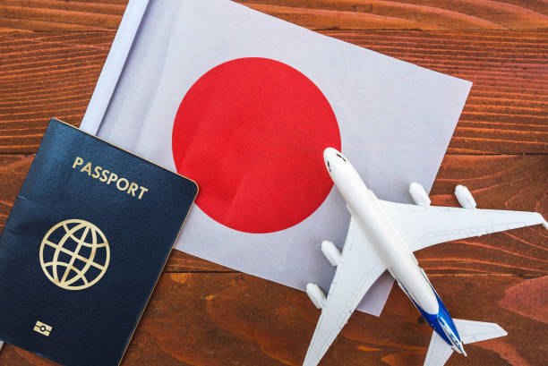 Flag of Japan with passport and toy airplane on wooden background. Flight travel concept japan visa stock pictures, royalty-free photos & images